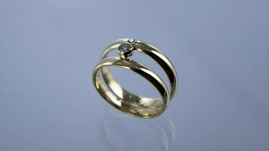 Voorbeeld vermaakte trouwringen naar ring met 2 banden en briljant geelgoud